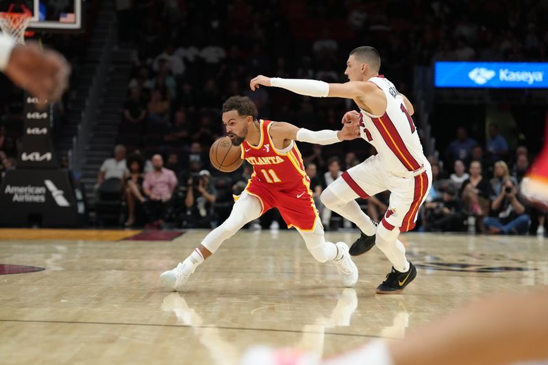 MIAMI, FL - OCTOBER 16: Trae Young #11 of the Atlanta Hawks dribbles the ball during the game against the Miami Heat during a preseason game on October 16, 2024 at Kaseya Center in Miami, Florida. NOTE TO USER: User expressly acknowledges and agrees that, by downloading and or using this Photograph, user is consenting to the terms and conditions of the Getty Images License Agreement. Mandatory Copyright Notice: Copyright 2024 NBAE (Photo by Eric Espada/NBAE via Getty Images)