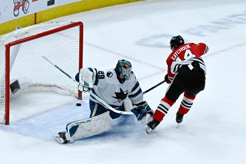 Jan 16, 2024; Chicago, Illinois, USA; Chicago Blackhawks left wing Boris Katchouk (14) scores the game winning overtime goal past San Jose Sharks goaltender Mackenzie Blackwood (29) during the third period at United Center. Mandatory Credit: Matt Marton-USA TODAY Sports