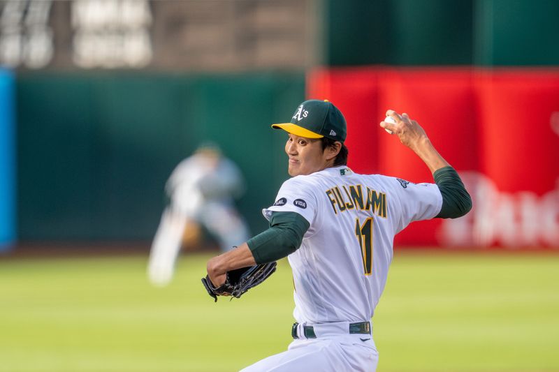 Jun 13, 2023; Oakland, California, USA; Oakland Athletics starting pitcher Shintaro Fujinami (11) delivers a pitch against the Tampa Bay Rays during the first inning at Oakland-Alameda County Coliseum. Mandatory Credit: Neville E. Guard-USA TODAY Sports