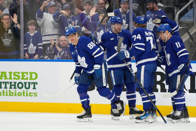 Oct 21, 2024; Toronto, Ontario, CAN;  Toronto Maple Leafs forward William Nylander (88) celebrates with teammates after scoring against Tampa Bay Lightning during the first period at Scotiabank Arena. Mandatory Credit: John E. Sokolowski-Imagn Images