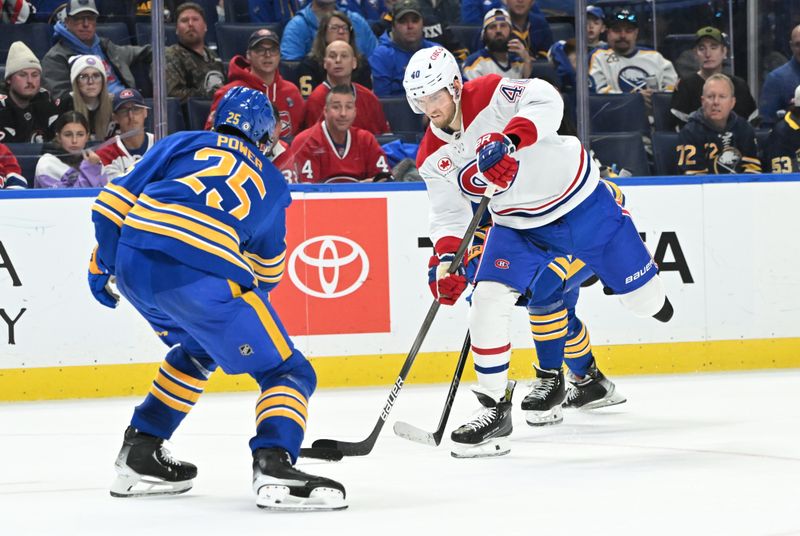 Nov 11, 2024; Buffalo, New York, USA; Montreal Canadiens right wing Joel Armia (40) takes a shot with Buffalo Sabres defenseman Owen Power (25) defending in the third period at KeyBank Center. Mandatory Credit: Mark Konezny-Imagn Images