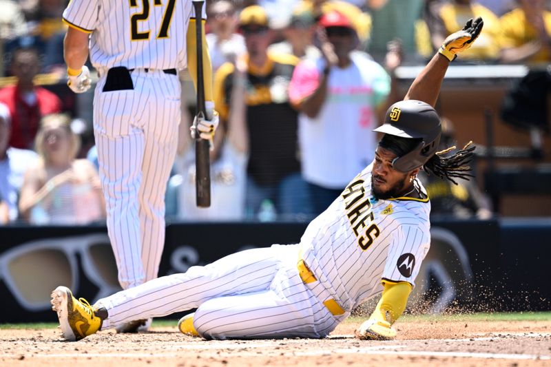 Jun 26, 2024; San Diego, California, USA; San Diego Padres third baseman Eguy Rosario (5) slides home to score a run on a wild pitch during the fourth inning against the Washington Nationals at Petco Park. Mandatory Credit: Orlando Ramirez-USA TODAY Sports