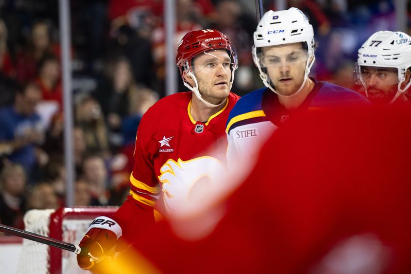 Dec 5, 2024; Calgary, Alberta, CAN; Calgary Flames center Jonathan Huberdeau (10) looks on after a whistle during the second period against the St. Louis Blues at Scotiabank Saddledome. Mandatory Credit: Brett Holmes-Imagn Images