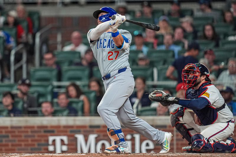 May 15, 2024; Cumberland, Georgia, USA; Chicago Cubs right fielder Seiya Suzuki (27)  hits a home run against the Atlanta Braves during the eighth inning at Truist Park. Mandatory Credit: Dale Zanine-USA TODAY Sports