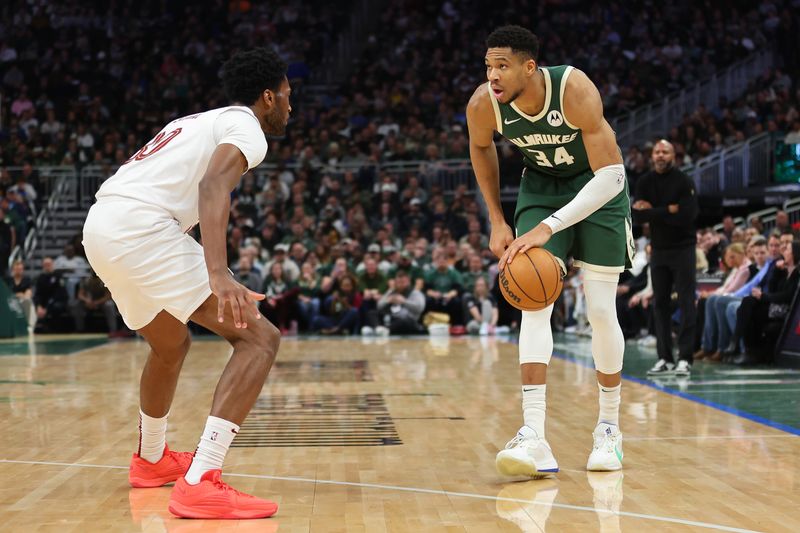 MILWAUKEE, WISCONSIN - JANUARY 24: Giannis Antetokounmpo #34 of the Milwaukee Bucks is defended by Damian Jones #30 of the Cleveland Cavaliers during a game at Fiserv Forum on January 24, 2024 in Milwaukee, Wisconsin. NOTE TO USER: User expressly acknowledges and agrees that, by downloading and or using this photograph, User is consenting to the terms and conditions of the Getty Images License Agreement. (Photo by Stacy Revere/Getty Images)