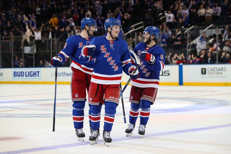 Sep 24, 2024; New York, New York, USA; New York Rangers left wing Alexis Lafreniere (13) celebrates a goal by New York Rangers center Adam Edstrom (not pictured) with defenseman Jacob Trouba (8) and defenseman Zac Jones (6) during the third period against the New York Islanders at Madison Square Garden. Mandatory Credit: Danny Wild-Imagn Images