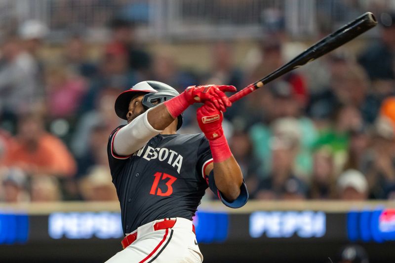 Jul 22, 2024; Minneapolis, Minnesota, USA; Minnesota Twins left fielder Manuel Margot (13) hits a two run RBI single against the Philadelphia Phillies in the fifth inning at Target Field. Mandatory Credit: Jesse Johnson-USA TODAY Sports