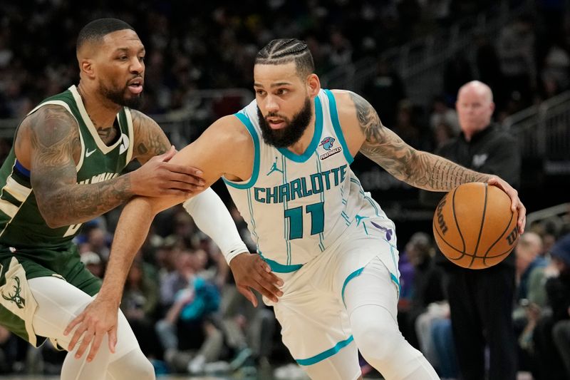 MILWAUKEE, WISCONSIN - FEBRUARY 27: Cody Martin #11 of the Charlotte Hornets dribbles the ball against Damian Lillard #0 of the Milwaukee Bucks during the first half at Fiserv Forum on February 27, 2024 in Milwaukee, Wisconsin. NOTE TO USER: User expressly acknowledges and agrees that, by downloading and or using this photograph, User is consenting to the terms and conditions of the Getty Images License Agreement. (Photo by Patrick McDermott/Getty Images)