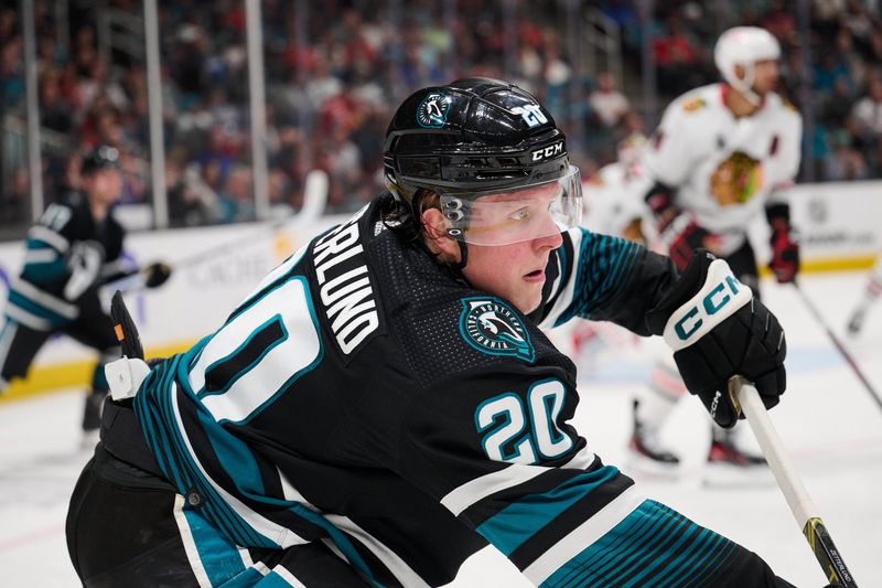 Mar 23, 2024; San Jose, California, USA; San Jose Sharks left wing Fabian Zetterlund (20) plays the puck against the Chicago Blackhawks during the second period at SAP Center at San Jose. Mandatory Credit: Robert Edwards-USA TODAY Sports