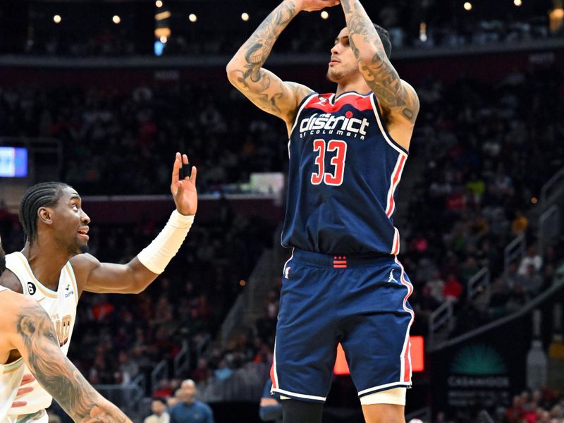 CLEVELAND, OHIO - MARCH 17: Kyle Kuzma #33 of the Washington Wizards shoots over Caris LeVert #3 of the Cleveland Cavaliers during the fourth quarter of the game at Rocket Mortgage Fieldhouse on March 17, 2023 in Cleveland, Ohio. The Cavaliers defeated the Wizards 117-94. NOTE TO USER: User expressly acknowledges and agrees that, by downloading and or using this photograph, User is consenting to the terms and conditions of the Getty Images License Agreement. (Photo by Jason Miller/Getty Images)