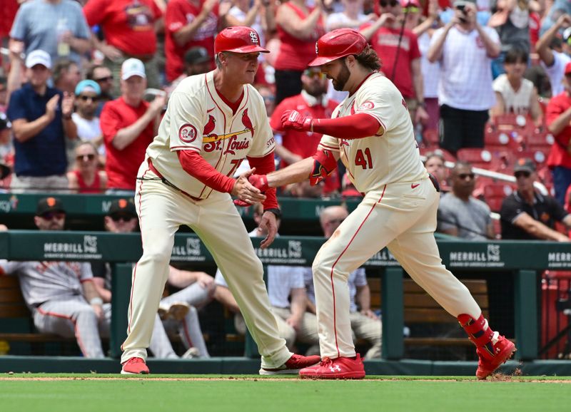 Jun 22, 2024; St. Louis, Missouri, USA; St. Louis Cardinals outfielder Alec Burleson (41) is congratulated by St. Louis Cardinals third base coach Ron 'Pop' Warner (75) as he heads to home plate after his home run against the San Francisco Giants in the fourth inning at Busch Stadium. Mandatory Credit: Tim Vizer-USA TODAY Sports