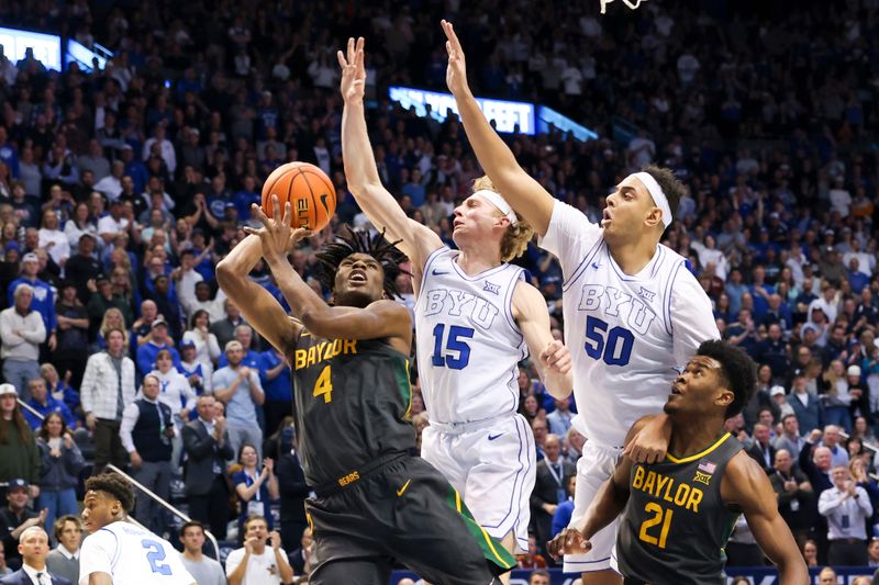 Feb 20, 2024; Provo, Utah, USA; Baylor Bears guard Ja'Kobe Walter (4) goes to the basket against Brigham Young Cougars guard Richie Saunders (15) and center Aly Khalifa (50) during the first half at Marriott Center. Mandatory Credit: Rob Gray-USA TODAY Sports