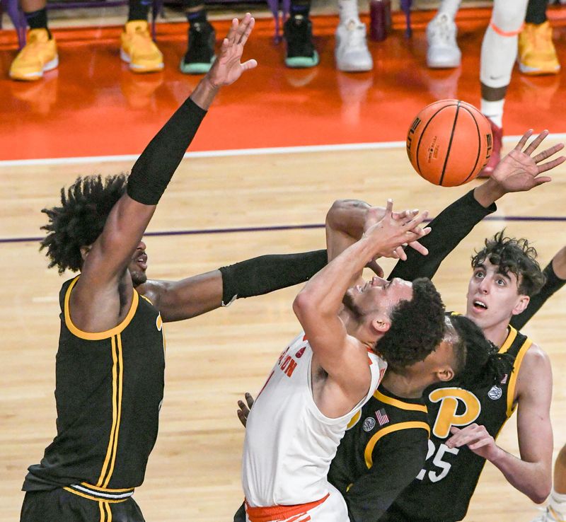 Feb 27, 2024; Clemson, South Carolina, USA;  Clemson senior guard Chase Hunter (1) is fouled taking a shot near Pitt forward Papa Amadou Kante (4) and forward Guillermo Diaz Graham (25) during the first half at Littlejohn Coliseum. Mandatory Credit: Ken Ruinard-USA TODAY Sports