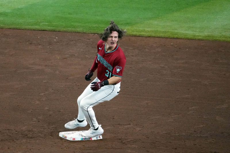 Jul 14, 2024; Phoenix, Arizona, USA; Arizona Diamondbacks outfielder Jake McCarthy (31) pulls into second base after a single and throwing error against the Toronto Blue Jays during the fifth inning at Chase Field. Mandatory Credit: Joe Camporeale-USA TODAY Sports