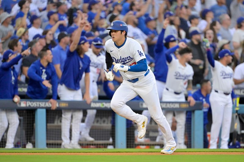 Oct 20, 2024; Los Angeles, California, USA; Los Angeles Dodgers designated hitter Shohei Ohtani (17) runs home to score after shortstop Tommy Edman (not pictured) hit a two RBI double in the first inning against the New York Mets during game six of the NLCS for the 2024 MLB playoffs at Dodger Stadium. Mandatory Credit: Jayne Kamin-Oncea-Imagn Images
