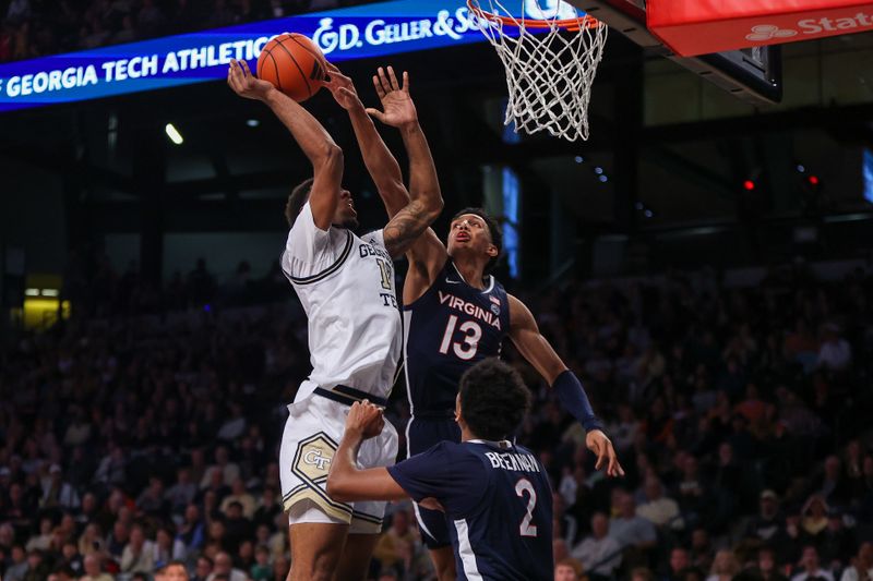 Jan 20, 2024; Atlanta, Georgia, USA; Georgia Tech Yellow Jackets forward Tyzhaun Claude (12) is fouled by Virginia Cavaliers guard Ryan Dunn (13) in the second half at McCamish Pavilion. Mandatory Credit: Brett Davis-USA TODAY Sports