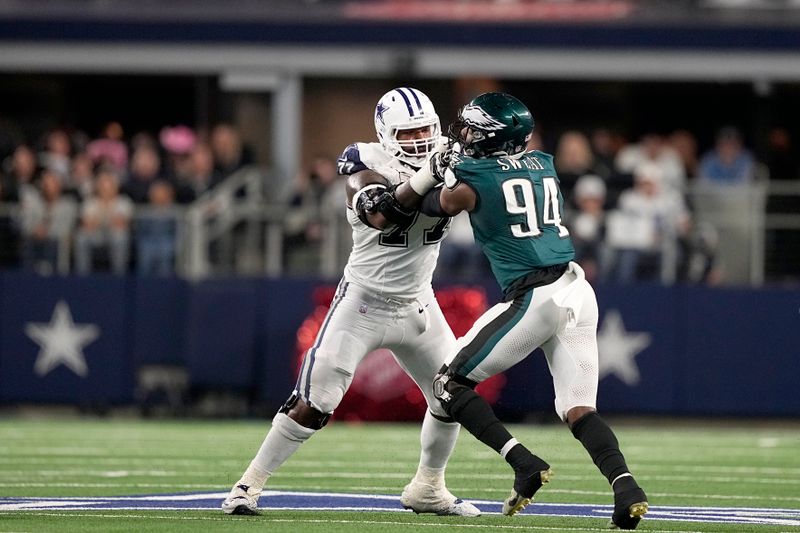 Dallas Cowboys' Tyron Smith (77) and Philadelphia Eagles' Josh Sweat (94) match up at the line of scrimmage during an NFL football game in Arlington, Texas, Sunday, Dec. 10, 2023. (AP Photo/Tony Gutierrez)