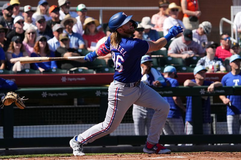 Mar 1, 2024; Scottsdale, Arizona, USA; Texas Rangers third baseman Jonathan Ornelas (36) hits a sacrifice fly RBI against the San Francisco Giants during the second inning at Scottsdale Stadium. Mandatory Credit: Joe Camporeale-USA TODAY Sports