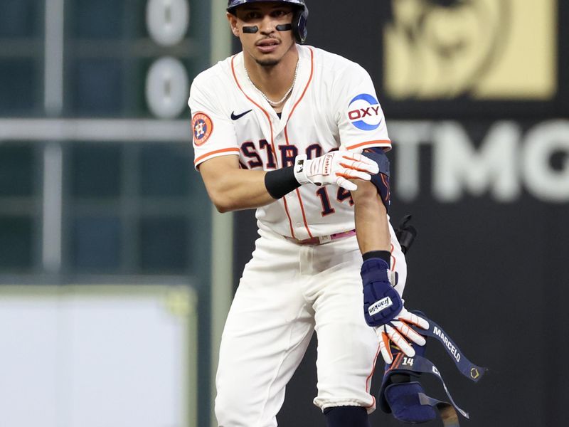 May 27, 2025; Houston, Texas, USA; Houston Astros second baseman Mauricio Dubon (14) reacts to his RBI double against the Athletics in the second inning at Daikin Park. Mandatory Credit: Thomas Shea-Imagn Images