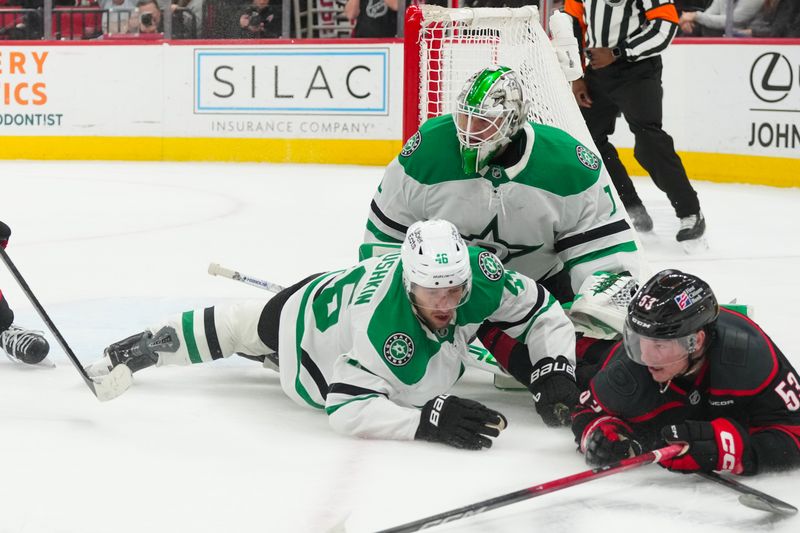 Jan 6, 2026; Raleigh, North Carolina, USA;  Dallas Stars goaltender Casey Desmith (1) and defenseman Ilya Lyubushkin (46) look for the puck against the Carolina Hurricanes right wing Jackson Blake (53) during the third period at Lenovo Center. Mandatory Credit: James Guillory-Imagn Images