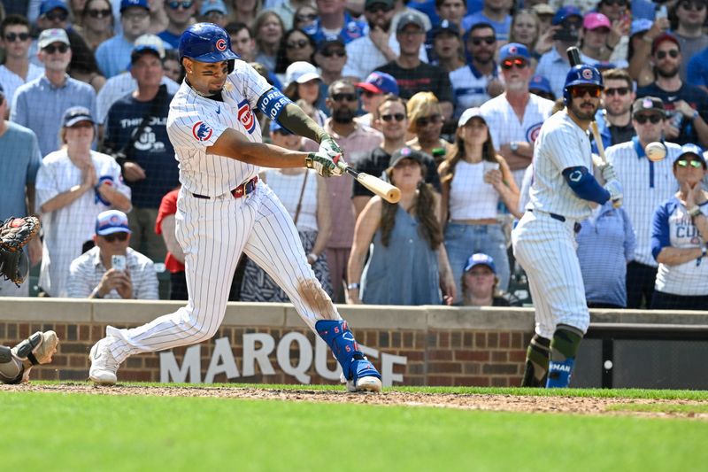 May 18, 2024; Chicago, Illinois, USA; Chicago Cubs third base Christopher Morel (5) hits a game winning RBI single against the Pittsburgh Pirates during the ninth inning at Wrigley Field. Mandatory Credit: Matt Marton-USA TODAY Sports