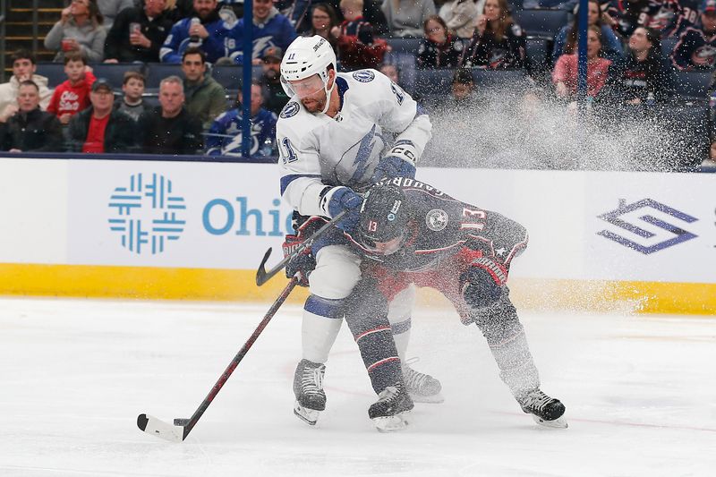 Feb 10, 2024; Columbus, Ohio, USA; Columbus Blue Jackets left wing Johnny Gaudreau (13) and Tampa Bay Lightning center Luke Glendening (11) chase down a loose puck during the third period at Nationwide Arena. Mandatory Credit: Russell LaBounty-USA TODAY Sports