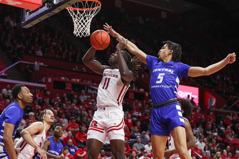 Nov 26, 2022; Piscataway, New Jersey, USA; Rutgers Scarlet Knights center Clifford Omoruyi (11) drives to the basket asCentral Connecticut State Blue Devils guard Kellen Amos (5) defends during the second half at Jersey Mike's Arena. Mandatory Credit: Vincent Carchietta-USA TODAY Sports