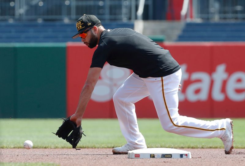 Aug 4, 2024; Pittsburgh, Pennsylvania, USA;  Pittsburgh Pirates infielder Isiah Kiner-Falefa (7) fields ground balls before the game against the Arizona Diamondbacks at PNC Park. Mandatory Credit: Charles LeClaire-USA TODAY Sports