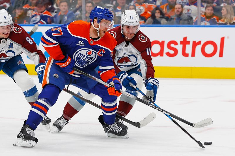Nov 8, 2025; Edmonton, Alberta, CAN; Colorado Avalanche forward Brock Nelson (11) tries to knock the puck away from Edmonton Oilers forward Connor McDavid (97) during the third period at Rogers Place. Mandatory Credit: Perry Nelson-Imagn Images