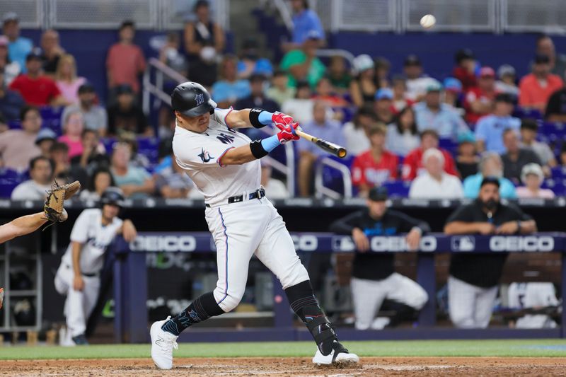 Jul 30, 2023; Miami, Florida, USA; Miami Marlins right fielder Avisail Garcia (24) hits a triple against the Detroit Tigers during the fifth inning at loanDepot Park. Mandatory Credit: Sam Navarro-USA TODAY Sports