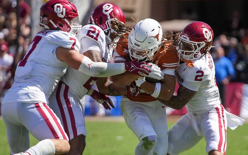 Oct 7, 2023; Dallas, Texas, USA; Texas Longhorns wide receiver Jordan Whittington (13) fights for yardage against Oklahoma Sooners linebacker Jaren Kanak (7), defensive back Reggie Pearson (21) and defensive back Billy Bowman Jr. (2) in the fourth quarter at the Cotton Bowl. This game makes up the 119th rivalry match up. Mandatory Credit: Ricardo B. Brazziell-USA TODAY Sports