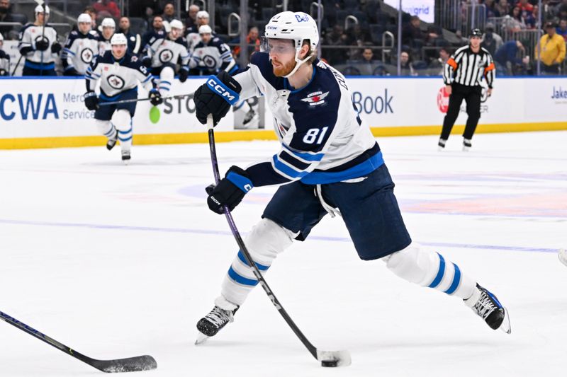 Mar 23, 2024; Elmont, New York, USA;  Winnipeg Jets left wing Kyle Connor (81) attempts a shot against the New York Islanders during the first period at UBS Arena. Mandatory Credit: Dennis Schneidler-USA TODAY Sports