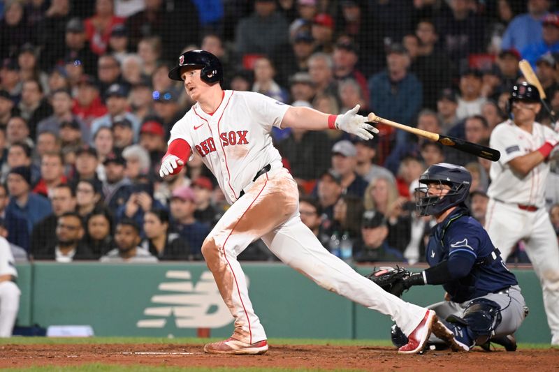 May 16, 2024; Boston, Massachusetts, USA;  Boston Red Sox designated hitter Garrett Cooper (28) hits an RBI double against the Tampa Bay Rays  during the fifth inning at Fenway Park. Mandatory Credit: Eric Canha-USA TODAY Sports