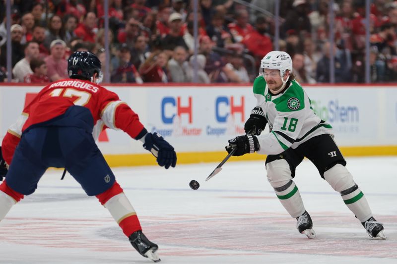 Nov 1, 2025; Sunrise, Florida, USA; Dallas Stars center Sam Steel (18) moves the puck agains tFlorida Panthers center Evan Rodrigues (17) during the first period at Amerant Bank Arena. Mandatory Credit: Sam Navarro-Imagn Images