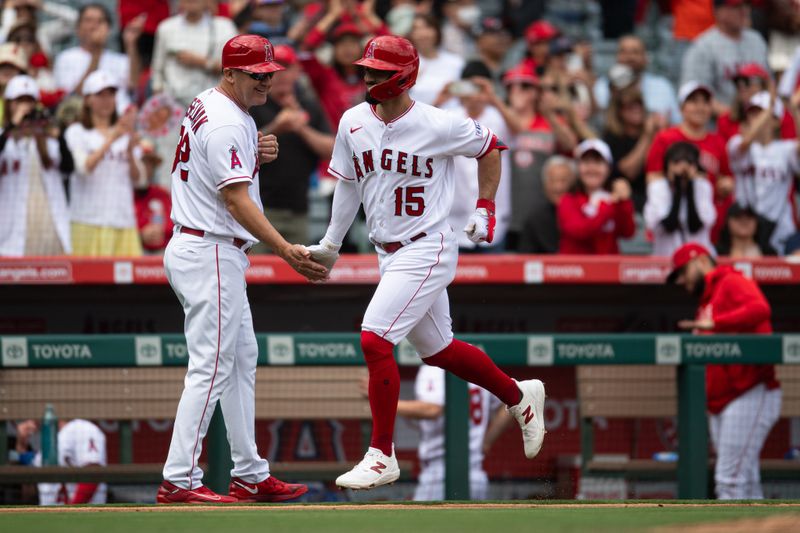 Oct 1, 2023; Anaheim, California, USA; Los Angeles Angels left fielder Randal Grichuk (15) celebrates with Los Angeles Angels third base coach Bill Haselman (82) after hitting a home run against the Oakland Athletics during the third inning at Angel Stadium. Mandatory Credit: Jonathan Hui-USA TODAY Sports