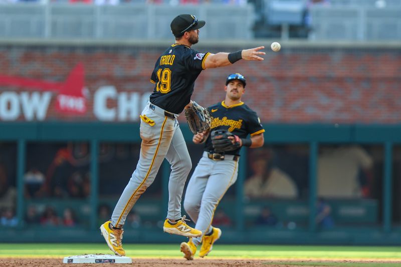 Sep 28, 2025; Cumberland, Georgia, USA; Pittsburgh Pirates shortstop Jared Triolo (19) throws the ball to first base for an out against the Atlanta Braves during the eighth inning at Truist Park. Mandatory Credit: Jordan Godfree-Imagn Images