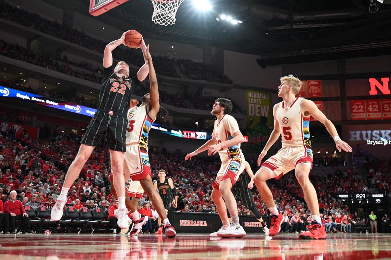 Feb 11, 2023; Lincoln, Nebraska, USA;  Wisconsin Badgers forward Steven Crowl (22) scores against Nebraska Cornhuskers forward Derrick Walker (13) in the second half at Pinnacle Bank Arena. Mandatory Credit: Steven Branscombe-USA TODAY Sports