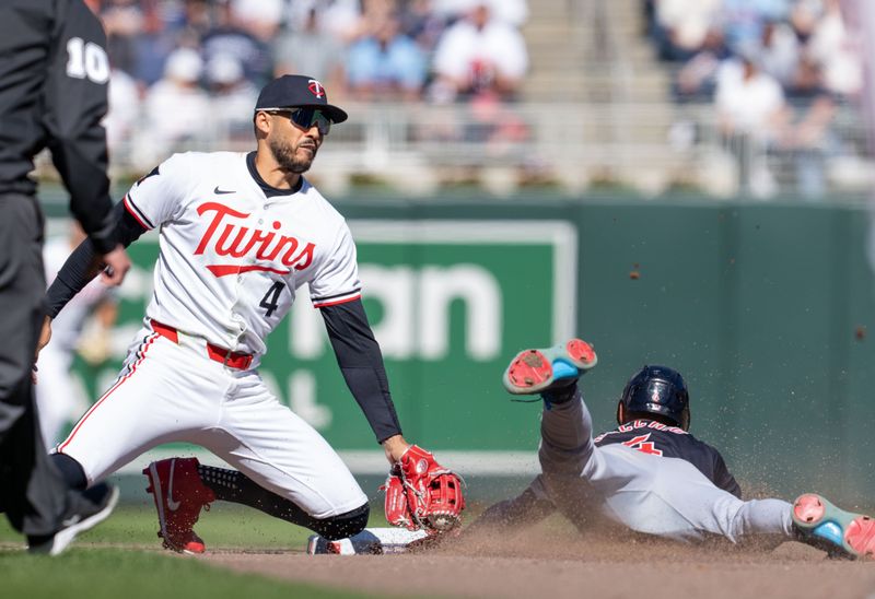 Apr 6, 2024; Minneapolis, Minnesota, USA; Minnesota Twins shortstop Carlos Correa (4) tags out Cleveland Guardians shortstop Brayan Rocchio (4) on an attempted steal in the seventh inning at Target Field. Mandatory Credit: Matt Blewett-USA TODAY Sports