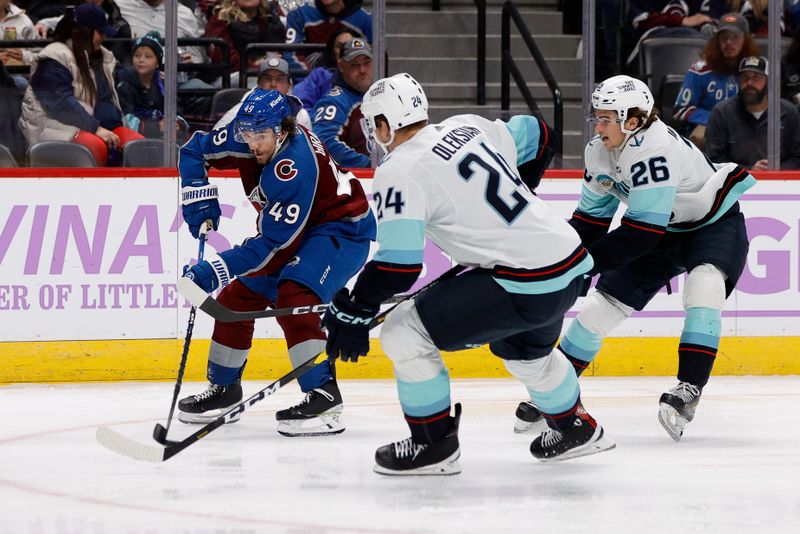 Nov 9, 2023; Denver, Colorado, USA; Colorado Avalanche defenseman Samuel Girard (49) controls the puck against Seattle Kraken defenseman Jamie Oleksiak (24) and center Ryan Winterton (26) in the second period at Ball Arena. Mandatory Credit: Isaiah J. Downing-USA TODAY Sports