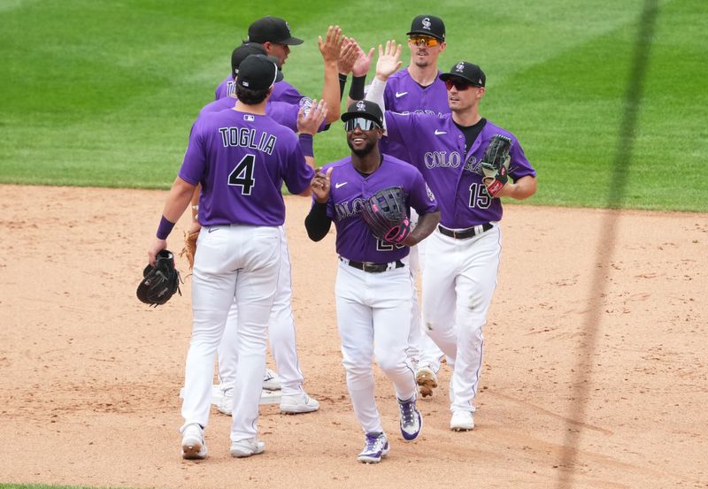 Jul 30, 2023; Denver, Colorado, USA; Colorado Rockies first baseman Michael Toglia (4) and left fielder Jurickson Profar (29) and center fielder Brenton Doyle (9) and right fielder Randal Grichuk (15) celebrate defeating the Oakland Athletics  at Coors Field. Mandatory Credit: Ron Chenoy-USA TODAY Sports