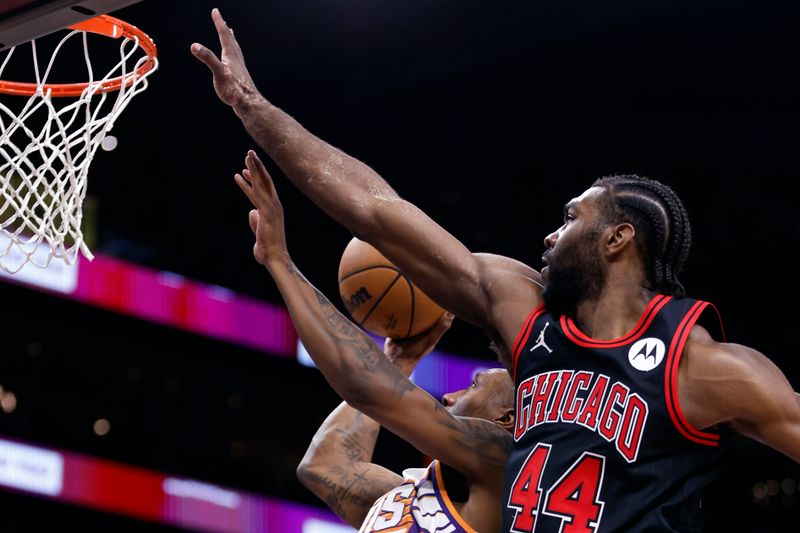 PHOENIX, ARIZONA - JANUARY 22: Saben Lee #38 of the Phoenix Suns attempts a layup against Patrick Williams #44 of the Chicago Bulls during the first half at Footprint Center on January 22, 2024 in Phoenix, Arizona. NOTE TO USER: User expressly acknowledges and agrees that, by downloading and or using this photograph, User is consenting to the terms and conditions of the Getty Images License Agreement.  (Photo by Chris Coduto/Getty Images)