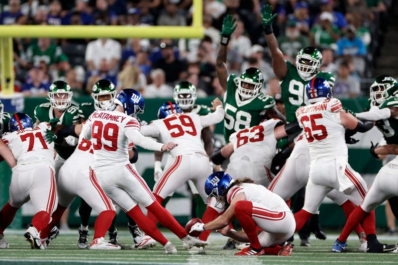 New York Giants place kicker Jude McAtamney (99) kicks a field goal during a preseason NFL football game against the New York Jets Saturday, Aug. 24, 2024, in East Rutherford, N.J. (AP Photo/Adam Hunger)