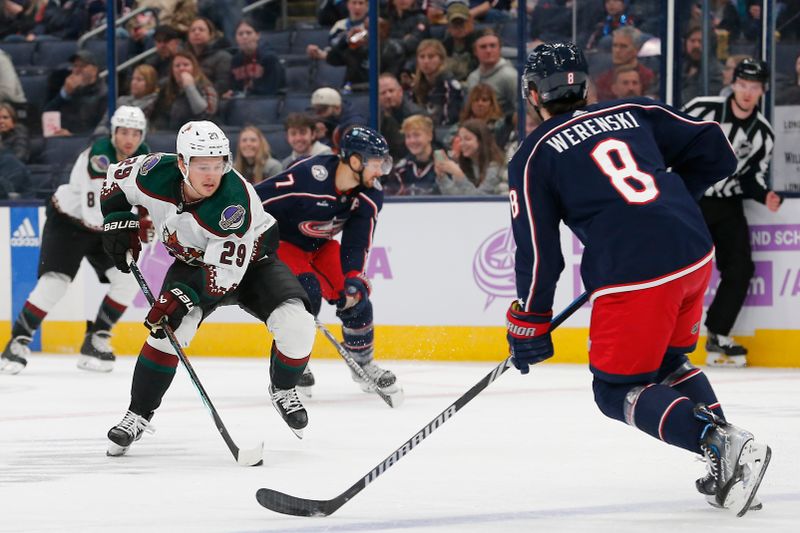 Nov 16, 2023; Columbus, Ohio, USA; Arizona Coyotes center Barrett Hayton (29) controls the puck as Columbus Blue Jackets defenseman Zach Werenski (8) defends during the first period at Nationwide Arena. Mandatory Credit: Russell LaBounty-USA TODAY Sports