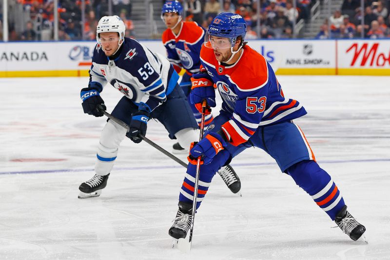 Sep 26, 2025; Edmonton, Alberta, CAN; Edmonton Oilers. forward Issac Howard (53) looks for a pass in front of Winnipeg Jets forward Danil Zhilkin (53) during the third period at Rogers Place. Mandatory Credit: Perry Nelson-Imagn Images