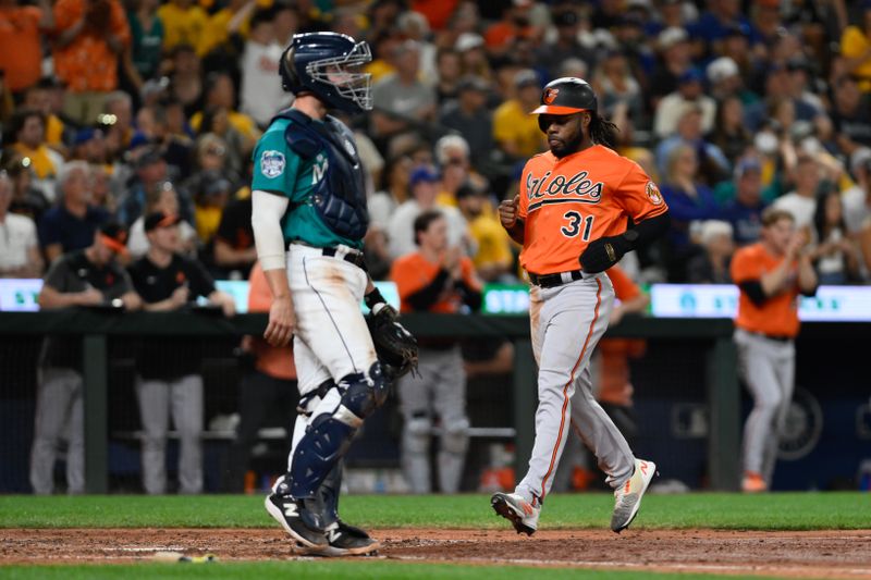 Aug 12, 2023; Seattle, Washington, USA; Baltimore Orioles center fielder Cedric Mullins (31) scores a run against the Seattle Mariners during the tenth inning at T-Mobile Park. Mandatory Credit: Steven Bisig-USA TODAY Sports