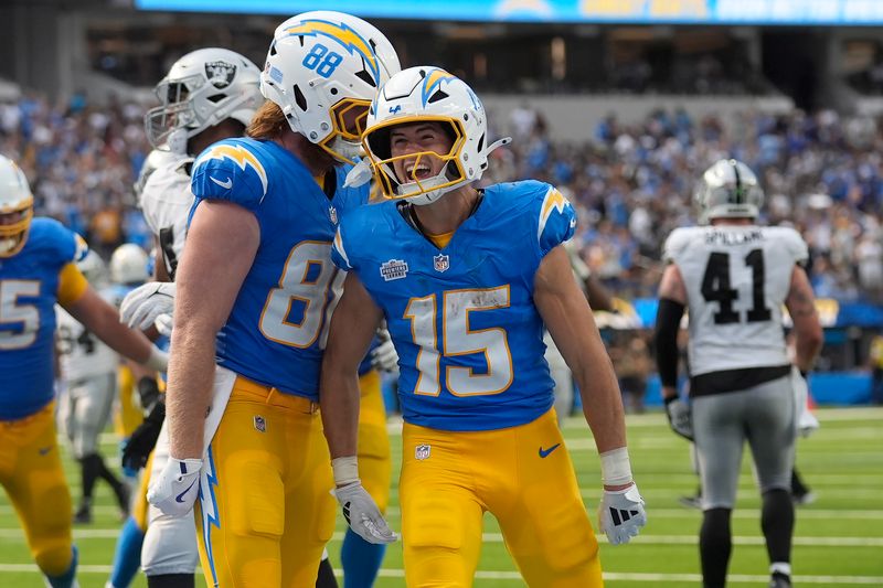 Los Angeles Chargers wide receiver Ladd McConkey (15) is congratulated by tight end Hayden Hurst (88) after scoring a touchdown against the Las Vegas Raiders during the second half of an NFL football game, Sunday, Sept. 8, 2024, in Inglewood, Calif. (AP Photo/Marcio Jose Sanchez)