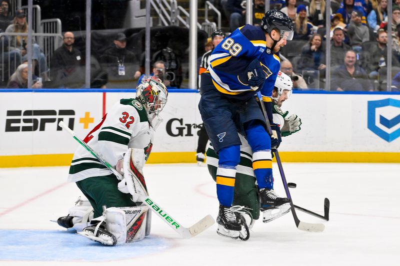 Nov 19, 2024; St. Louis, Missouri, USA;  St. Louis Blues left wing Pavel Buchnevich (89) skates in front of Minnesota Wild goaltender Filip Gustavsson (32) during the second period at Enterprise Center. Mandatory Credit: Jeff Curry-Imagn Images