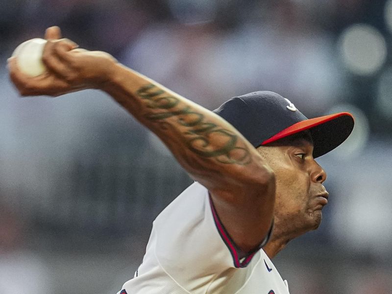 May 20, 2024; Cumberland, Georgia, USA; Atlanta Braves relief pitcher Raisel Iglesias (26) pitches against the San Diego Padres during the ninth inning at Truist Park.Mandatory Credit: Dale Zanine-USA TODAY Sports