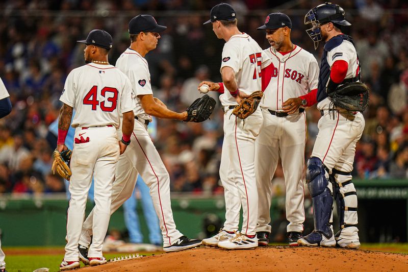 Aug 29, 2024; Boston, Massachusetts, USA; Boston Red Sox manager Alex Cora (13) hands over the ball to relief pitcher Rich Hill (44) in the seventh inning at Fenway Park. Mandatory Credit: David Butler II-USA TODAY Sports