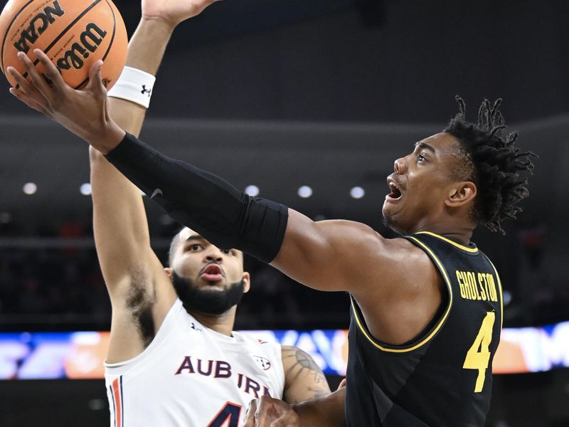 Feb 14, 2023; Auburn, Alabama, USA;  Missouri Tigers guard DeAndre Gholston (4) shoots around Auburn Tigers forward Johni Broome (4) during the first half at Neville Arena. Mandatory Credit: Julie Bennett-USA TODAY Sports